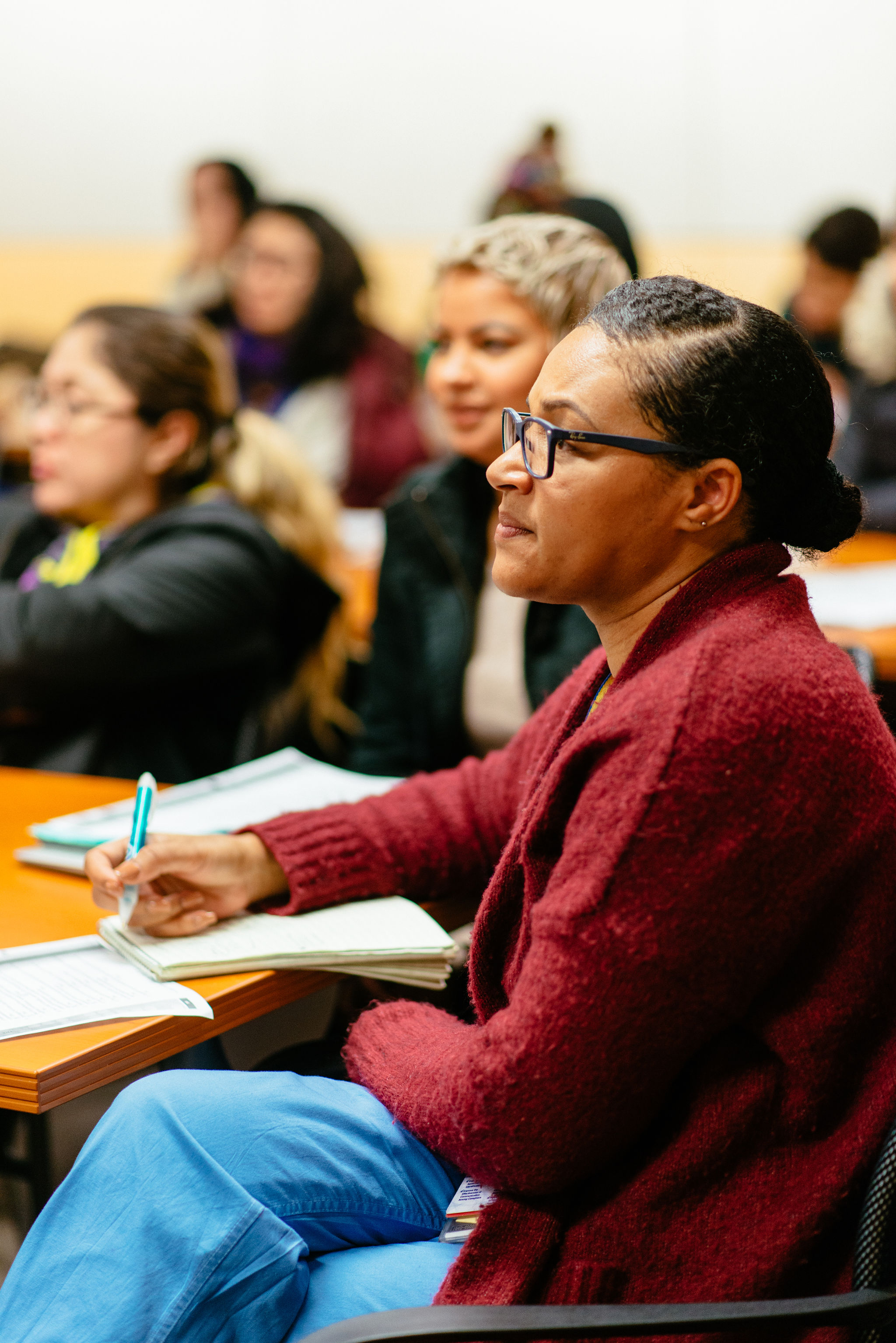 Student taking notes during class, 2018.